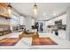 Bright open kitchen with quartz countertops, stainless steel appliances, and pendant lighting at 4245 Guilford Ave, Indianapolis, IN 46205