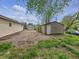Backyard showing the driveway, grass, detached garage and landscaping at 425 S Oakland Ave, Indianapolis, IN 46201