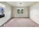 Bedroom with neutral walls, carpet flooring, and natural light from the windows at 425 S Oakland Ave, Indianapolis, IN 46201