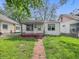 Charming single-story home featuring a cozy front porch, red brick stairs, and a well-kept lawn at 425 S Oakland Ave, Indianapolis, IN 46201