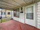Front porch with red painted concrete, a white door and the house number at 425 S Oakland Ave, Indianapolis, IN 46201