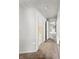 Hallway with carpet flooring, featuring doorways leading to various rooms at 425 S Oakland Ave, Indianapolis, IN 46201