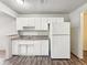 Compact kitchen with white cabinets, a double sink, and basic appliances, designed for efficient meal prep at 425 S Oakland Ave, Indianapolis, IN 46201