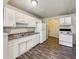 Functional kitchen featuring white appliances, ample cabinet space, and a double stainless steel sink at 425 S Oakland Ave, Indianapolis, IN 46201