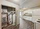 This kitchen features white cabinets, a white refrigerator, and wood-look flooring, awaiting your personal touch at 425 S Oakland Ave, Indianapolis, IN 46201