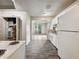 Bright kitchen with white appliances and cabinets, offering a view into the adjacent living space at 425 S Oakland Ave, Indianapolis, IN 46201