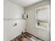 Laundry room featuring laminate flooring and a window to provide light at 425 S Oakland Ave, Indianapolis, IN 46201