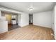 Inviting living room with wood-look floors leading to a kitchen with white appliances and cabinetry at 425 S Oakland Ave, Indianapolis, IN 46201
