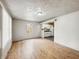 Bright living room featuring hardwood floors, a neutral color palette, and an open doorway to the kitchen at 425 S Oakland Ave, Indianapolis, IN 46201