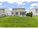 A spacious backyard with a well-maintained lawn, screened-in porch with seating, and privacy landscaping at 4629 Rainwater Ln, Whitestown, IN 46075