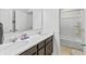 Bathroom featuring a double vanity with quartz countertops, undermount sinks, and a shower-tub combination at 4629 Rainwater Ln, Whitestown, IN 46075
