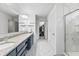 Modern bathroom featuring a double sink vanity and marble-look tile and glass shower at 4629 Rainwater Ln, Whitestown, IN 46075
