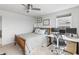This bedroom features a bed, ceiling fan, a gray carpet, and a modern workspace with dual monitors at 4629 Rainwater Ln, Whitestown, IN 46075