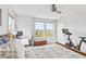 Sunlit bedroom showcasing a bed, a ceiling fan, and two windows that provide views of the surrounding landscape at 4629 Rainwater Ln, Whitestown, IN 46075
