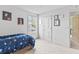 Bright bedroom with white walls, carpet, space-themed décor, and a door leading to another room at 4629 Rainwater Ln, Whitestown, IN 46075