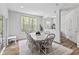 Bright dining room features large window and a stylish table with seating for six at 4629 Rainwater Ln, Whitestown, IN 46075