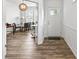 Inviting entryway featuring wood floors, white trim, and a view into a stylish home office at 4629 Rainwater Ln, Whitestown, IN 46075