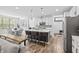 Bright, open kitchen with island seating, stainless steel appliances, and a dining area at 4629 Rainwater Ln, Whitestown, IN 46075
