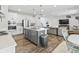 Modern kitchen with stainless steel appliances, island with seating, and open layout to living room at 4629 Rainwater Ln, Whitestown, IN 46075