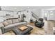 Spacious living room seamlessly connects to the modern kitchen and staircase at 4629 Rainwater Ln, Whitestown, IN 46075