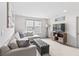 Bright and inviting living room with a sectional couch, ottoman, TV and natural light at 4629 Rainwater Ln, Whitestown, IN 46075