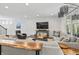 Open living area features a large sectional, media console, and well-lit windows at 4629 Rainwater Ln, Whitestown, IN 46075