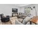 Well-lit living room featuring a large sectional, entertainment center, and bright windows at 4629 Rainwater Ln, Whitestown, IN 46075