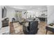 Comfortable living space with gray sofas, large windows, and a view into the modern kitchen at 4629 Rainwater Ln, Whitestown, IN 46075