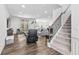 Spacious, open-concept living area with plush seating, modern staircase, and ample natural light at 4629 Rainwater Ln, Whitestown, IN 46075