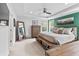 Bright main bedroom with tray ceiling, accent wall, and warm wood furnishings at 4629 Rainwater Ln, Whitestown, IN 46075