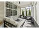 Relaxing covered porch featuring comfortable seating and stylish decor overlooking the neighborhood at 4629 Rainwater Ln, Whitestown, IN 46075