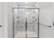 Modern glass enclosed shower with marble-look tile surround and window at 4629 Rainwater Ln, Whitestown, IN 46075