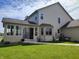 Well-maintained backyard with lush green grass, a covered patio, and siding at 4719 Arabian Run, Indianapolis, IN 46228