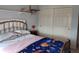 Bedroom showcasing a metal bed frame, closet with sliding doors, and a shelf with decorations at 4719 Arabian Run, Indianapolis, IN 46228