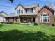 Charming two-story home with a brick facade, blue shutters, and a beautifully landscaped front yard at 4719 Arabian Run, Indianapolis, IN 46228