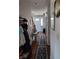 Inviting hallway with wood floors, a patterned rug, and a view of the front door at 4719 Arabian Run, Indianapolis, IN 46228