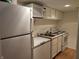 Compact kitchen featuring white appliances and wood flooring at 4719 Arabian Run, Indianapolis, IN 46228