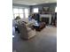 Comfortable living room featuring neutral carpeting, a fireplace, and large windows at 4719 Arabian Run, Indianapolis, IN 46228