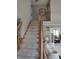Carpeted staircase with wood railings leading to the upper level of the home at 4719 Arabian Run, Indianapolis, IN 46228