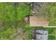 This aerial image captures a backyard with a wooden deck, patio set, mature trees, and lush green grass at 4810 Winthrop Ave, Indianapolis, IN 46205