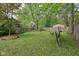 Spacious backyard with a large lawn, mature trees, and a wooden fence for privacy at 4810 Winthrop Ave, Indianapolis, IN 46205