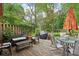 Backyard featuring wooden deck, green grass, wooden fence, and a dining table with chairs at 4810 Winthrop Ave, Indianapolis, IN 46205