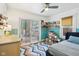 Bright bedroom featuring a sliding door, shelving with books and toys, and large window at 4810 Winthrop Ave, Indianapolis, IN 46205