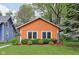Charming orange single-story home with a well-maintained lawn and green shrubbery at 4810 Winthrop Ave, Indianapolis, IN 46205