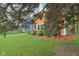 The front yard and exterior of an orange single-story home with green shrubbery at 4810 Winthrop Ave, Indianapolis, IN 46205