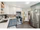 Updated kitchen showcasing stainless steel appliances, white and gray cabinetry, and ample counter space at 4810 Winthrop Ave, Indianapolis, IN 46205