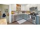 Updated kitchen showcasing stainless steel appliances, white and gray cabinetry, and ample counter space at 4810 Winthrop Ave, Indianapolis, IN 46205