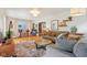 Inviting living room features hardwood floors, a stylish rug, and comfortable, neutral-toned furniture at 4810 Winthrop Ave, Indianapolis, IN 46205