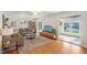 Bright living room with hardwood floors, comfortable seating, and a view into the sun room at 4810 Winthrop Ave, Indianapolis, IN 46205