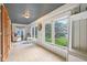 Bright sunroom with large windows, light tile flooring and a tranquil view of the outdoors at 4810 Winthrop Ave, Indianapolis, IN 46205